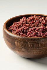 A bowl of food with a lot of red meat in it