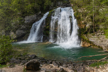 Bovec, Slovenia. Visje waterfalls. Nature trail crystal clear, turquoise water. easy trekking, nature experience, wood path. Waterfalls inside a forest, long photographic exposure, power of nature.
