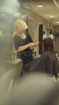Beauty Salon Experience: Professional Hairdresser Styling Hair for a Stylish European Woman, Lifestyle Transformation with Fashionable Haircut and Hairstyle Done by a Skilled Professional.
