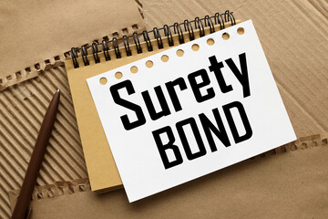 Surety bond craft notebook on a craft background. text on white page