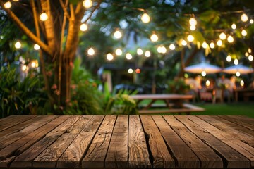 Wooden table in backyard at night with party blurred background