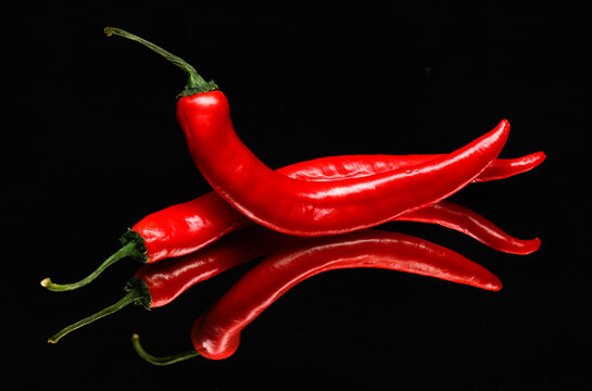 red chili peppers on a black background