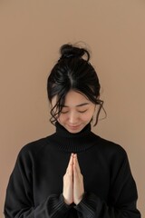 Asian woman with prayer hands pose, or the prayer mountain pose.