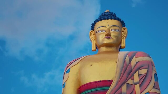 Closeup shot of Langza buddha statue against blue sky with clouds at Langza village in Spiti Valley, Himachal Pradesh, India. Buddha statue in a village in Spiti valley at high altitude.