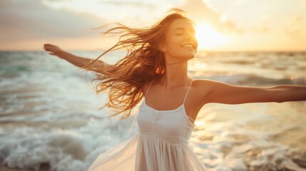 A beautiful woman in a white dress spreads her hands wide and embraces freedom on the beach, Sunrise, or sunset on a sandy beach. 