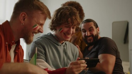Italian fans cheering for favorite Italy team, watching match on smartphone. Europe Sport football. Soccer cup. Football, sports and soccer fans. Slow Motion