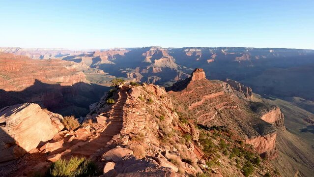 wide pan of the horizon of the south rim of the Grand Canyon from the South Kaibab Trail with morning light and shadows on canyon walls