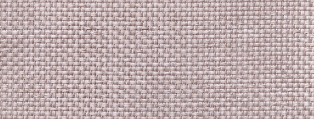 Texture of light gray background from woven textile material with wicker pattern, macro. Vintage ivory fabric