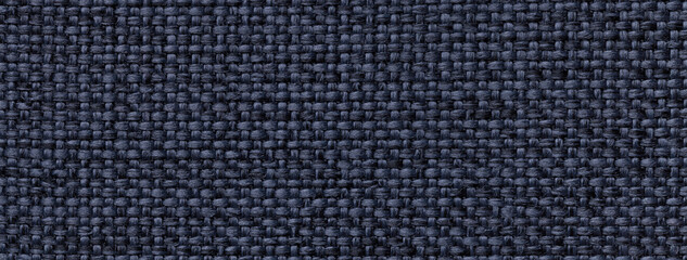 Texture of navy blue color background from woven textile material with wicker pattern, macro. Vintage fabric