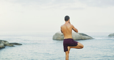 Man, yoga and tree pose for balance at sea or wellness peace for vrksasana, rear view or...