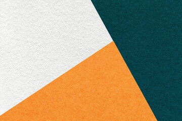 Texture of craft emerald, white and orange shade color paper background, macro. Vintage abstract teal cardboard