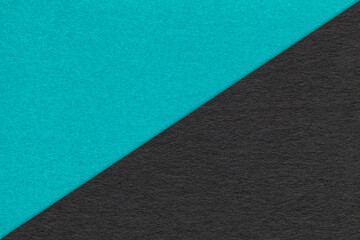 Texture of craft turquoise and black paper background, half two colors, macro. Vintage kraft cerulean cardboard.