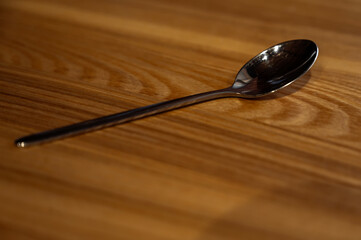 teaspoon on a wooden table, in a cafe