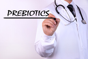 Doctor writing word Prebiotics with marker Medical concept