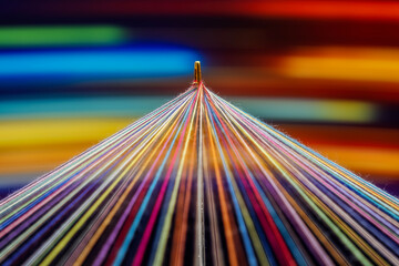 Converging Multi-colored Sewing Thread with motion blur effect on a rotating table, colorful background