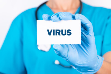 Doctor holding a card with text VIRUS, medical concept.