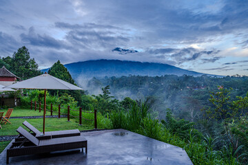 Luxury Resort Patio Overlooking Misty Mountain at Dawn (Mount Agung)