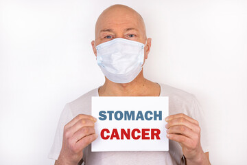 A sick man holds a tablet with the text Stomach Cancer. Medical concept.