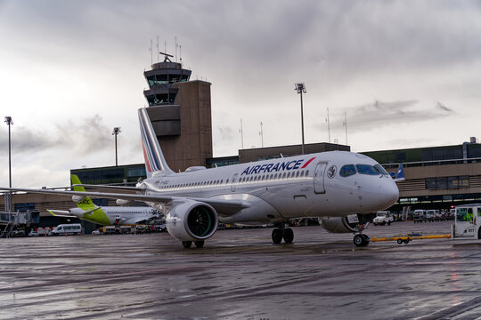 Air France airplane Airbus A220-300 registration F-HZUZ doing pushback by aircraft tug at Swiss airport Zürich Kloten on a spring evening. Photo taken April 9th, 2024, Kloten, Switzerland.