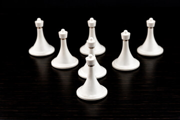 White chess pieces on a chessboard on a dark background. Business concept. Game, strategy, wisdom,...