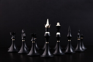 Black chess pieces on a chessboard on a dark background. Business concept. Game, strategy, wisdom,...