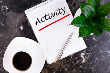 Activity Business concept. Notebook on an grey table with a cup of coffee and pen.