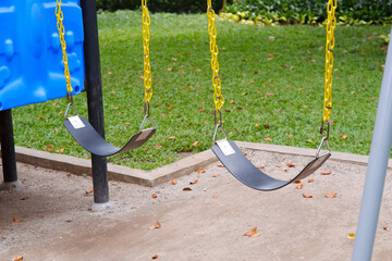 empty and deserted children's iron swing in the park