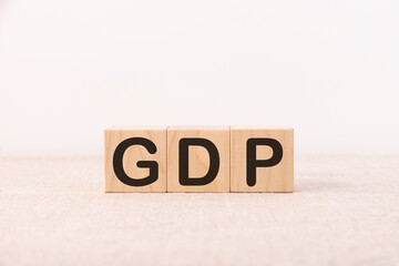 GDP, Gross Domestic Product concept, cube wooden block with alphabet combine abbreviation GDP,...