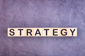 STRATEGY word made with wood building blocks.