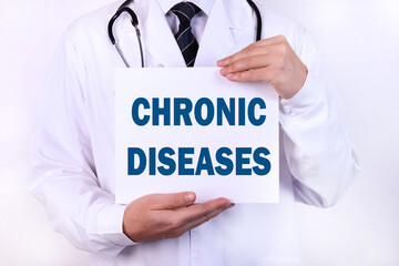 Doctor keeps a card with the name of the diagnosis - chronic disease. Medical concept.