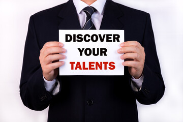 Businessman holding a card with text Discover Your Talents
