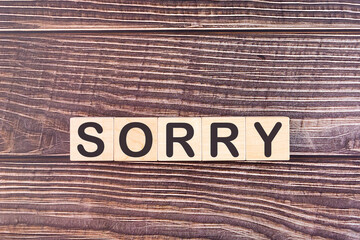 SORRY word made with wood building blocks