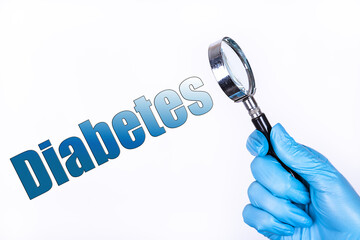 DIABETES text written on the background of a magnifying glass in the doctor hand in a medical...