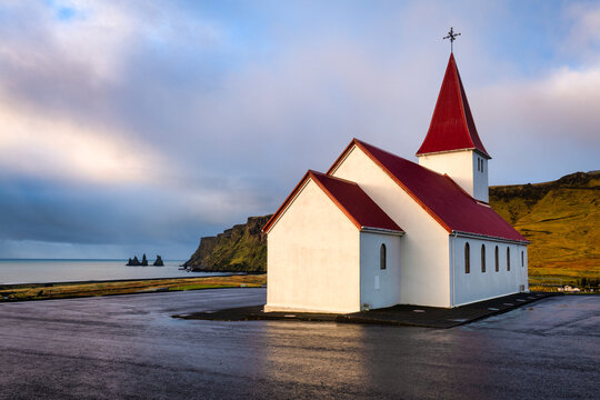 Vikurkirkja (Reynir's Church) and Reynisdrangar sea stacks at sunrise, Vik, Southern Iceland, Iceland