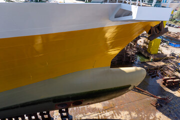 big yellow roro vessel inside a dry dock for repair