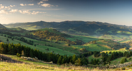 Gree hills and meadows at Pieniny Mountains. Beautiful wide spring panoramic view from. Wysoki Wierch, Poland and Slovakia.