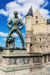 Bronze statue of De Lange Wapper and Het Steen, historic castle, Antwerp, Belgium