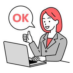 OKの合図をするノートパソコンで仕事をするスーツの女性