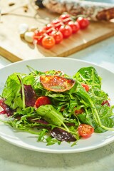 Salad of greens and fried garlic, cherry tomatoes and Chorizo sausage. The cooking process, step-by-step recipe