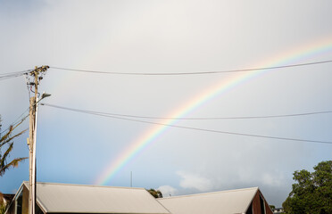 Rainbow over the houses after the rain. Auckland. - 788035905