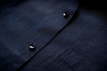Close up of dark Men's shirt. Soft focus. Copy space.	
