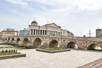 
Skopje, North Macedonia - 31.03.2024: Archaeological Museum of Macedonia and Bridge of the Civilizations in downtown of Skopje, on a sunny morning during spring. 