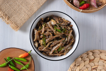 Green chili anchovies, typical Indonesian food. served in a small bowl.