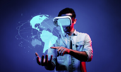 Smart man using VR goggle to connect global network connection. Happy man with casual cloth access...