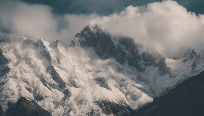 a snowy mountain is shown with clouds above it