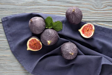  Fresh ripe figs on a wooden background © Atlas