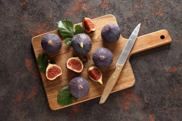  Fresh ripe figs with a knife on a wooden board © Atlas