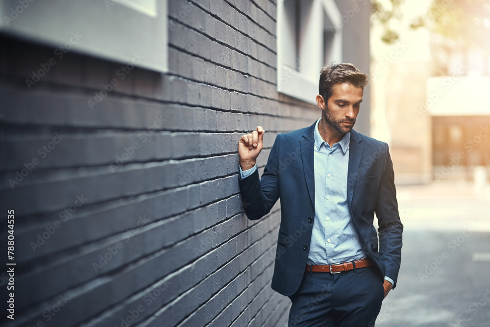 Wall mural Serious, businessman and thinking in city by wall for corporate fashion, trendy and stylish suit. Male entrepreneur, professional and confident in street for travel to work or company and outdoor.