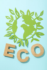 The word eco with a paper model of the Earth