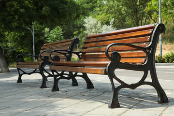 Beautiful wooden benches stand on the street